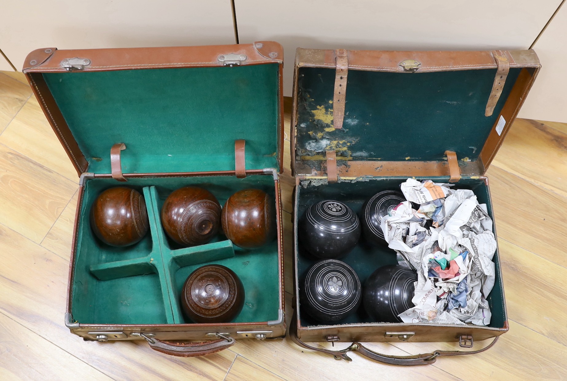 A set of four Slazengers bowls balls and another set of four Douglas Kenn ltd. ‘Henselite’ bowls balls, both in leather cases